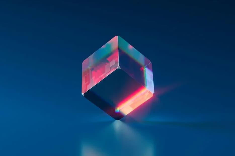 An abstract, floating cube with a translucent and reflective surface, casting a red and blue light, giving the impression of a holographic display.