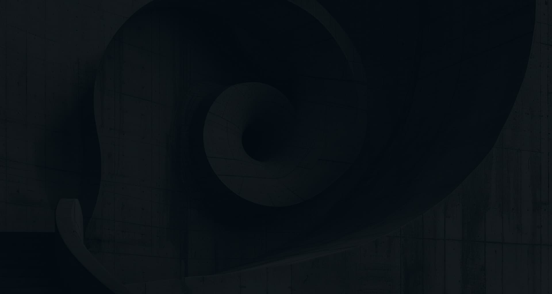 A dark, abstract architectural detail of a spiraling form, reminiscent of a nautilus shell or a spiral staircase, viewed from below.
