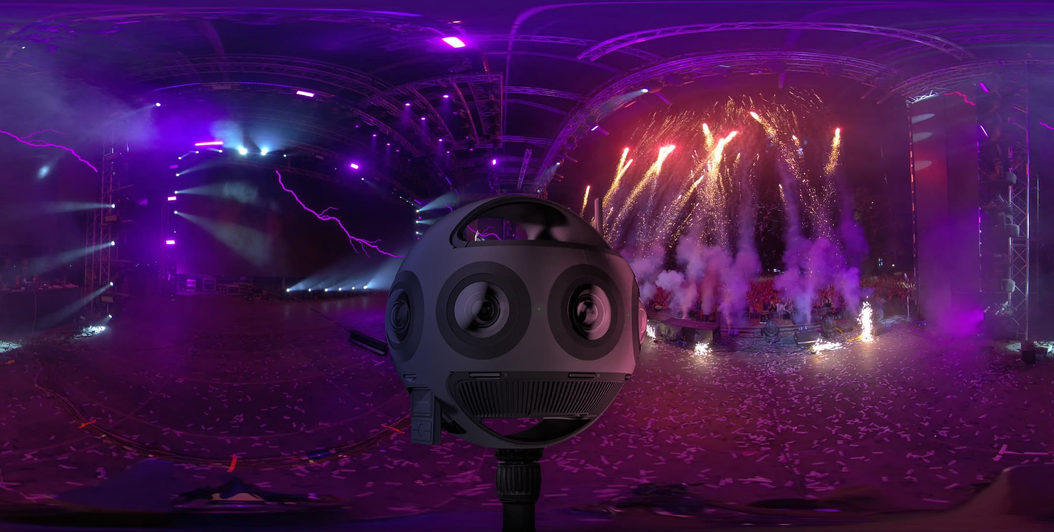 360-degree virtual reality camera capturing an indoor concert with vibrant stage lights, fireworks, and dynamic effects in an immersive environment.